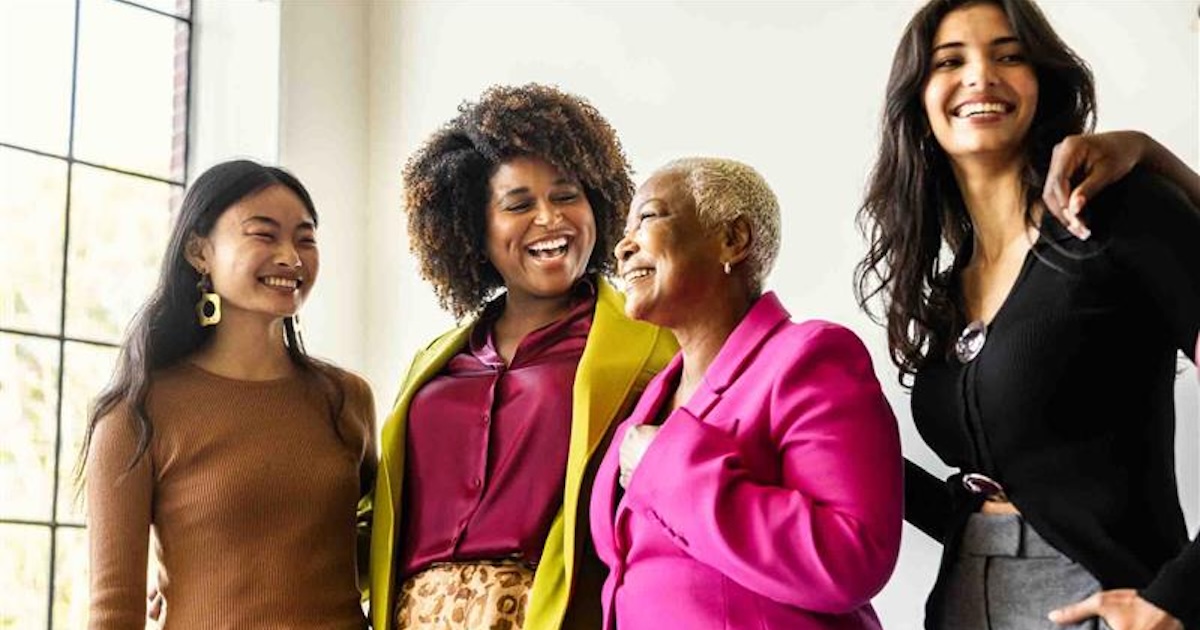 Group of friends standing together and laughing Group of friends standing together and laughing