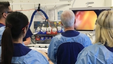 Surgeons performing a colonoscopy as part of a bowel screening