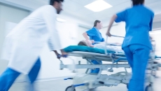 Emergency staff transporting a patient on a gurney