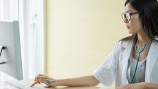 A doctor using a desktop computer