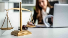 Shot of lawyer hammer and equality scales of justice in courtroom