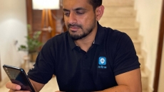 MFine CTO Ajit Narayanan holding a smartphone to measure his vitals