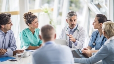 medical providers and business people sit around table