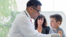 Doctor giving injection to pediatric patient