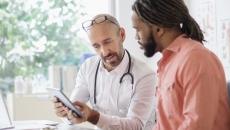 Health care professional consulting with patient