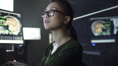 Person at a desk looking at a computer