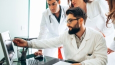 Clinicians looking at a screen