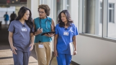 A doctor and nurses walking together in a hospital.