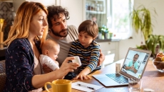 A family talking to a doctor on their laptop.
