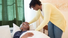 A patient in bed with an attendant nurse
