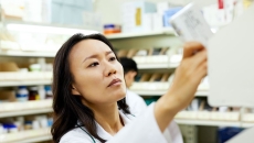 A pharmacist pulling a medication off a shelf