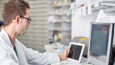 A pharmacist working at a desk