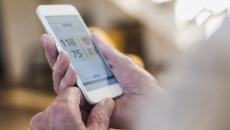 A close up of a smartphone displaying blood pressure trends
