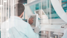 Healthcare researcher looking at a computer while in a lab