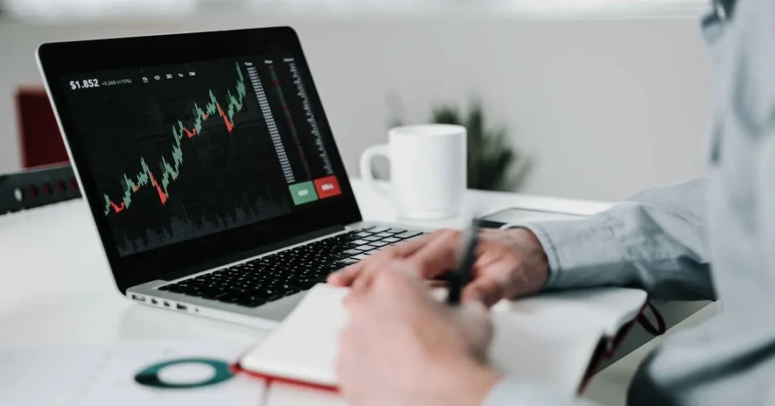 Young businessman using laptop for analyzing data stock market