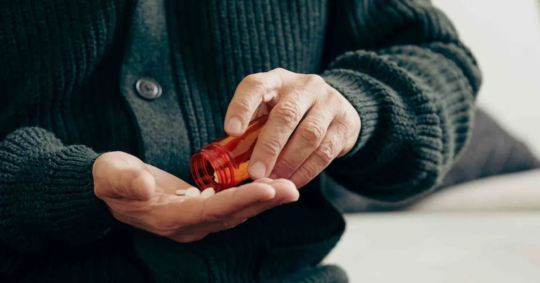 Person pouring pills into their hand