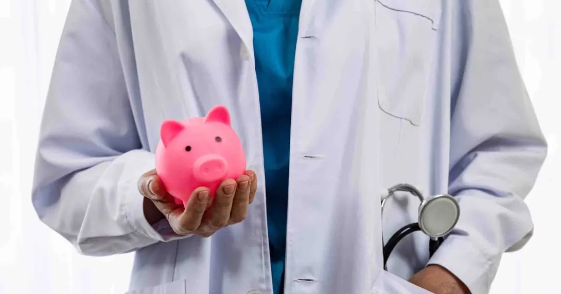 Doctor holding a piggy bank