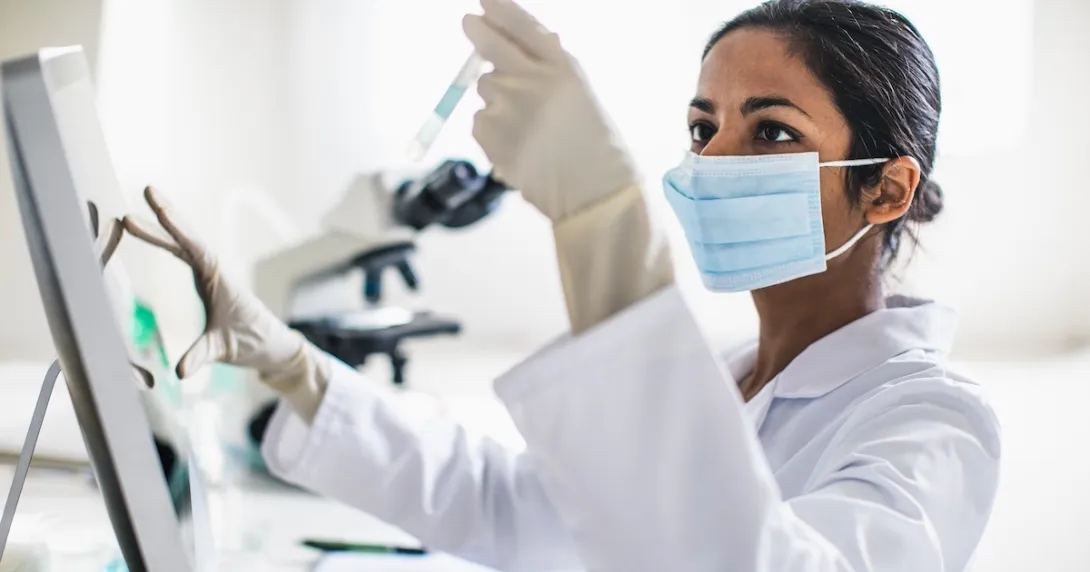 Scientist analyzing contents of test tube