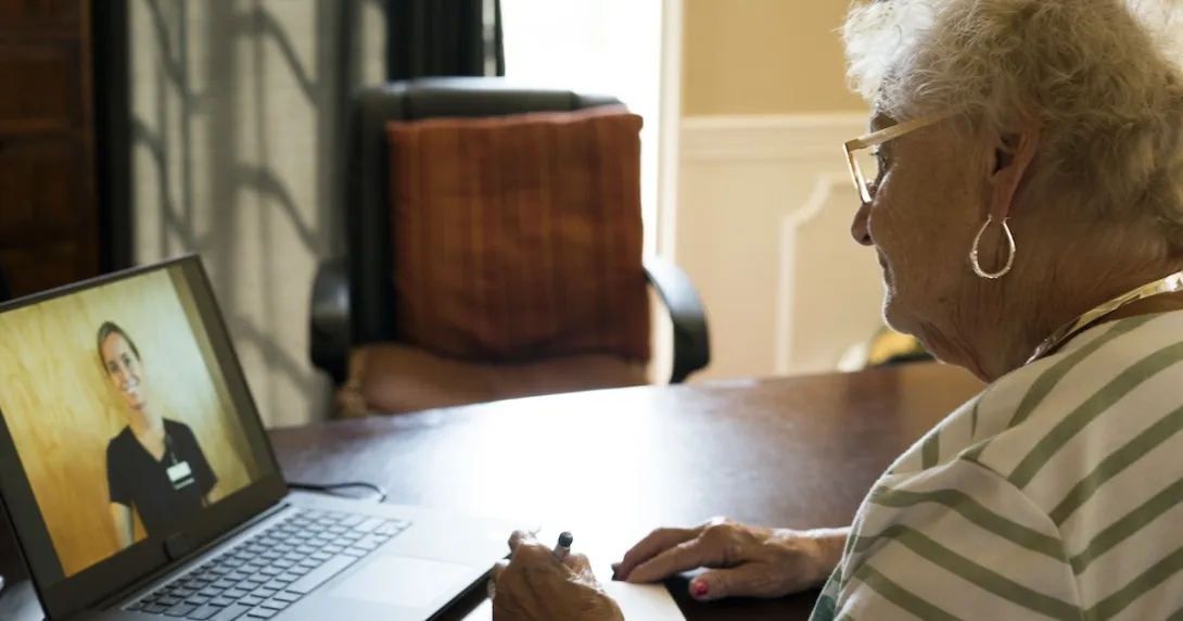 Patient consulting with healthcare practitioner via laptop computer
