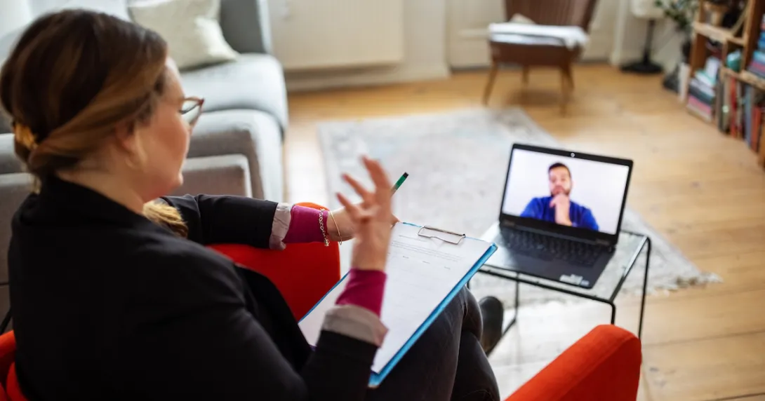 People talking with each other via laptop