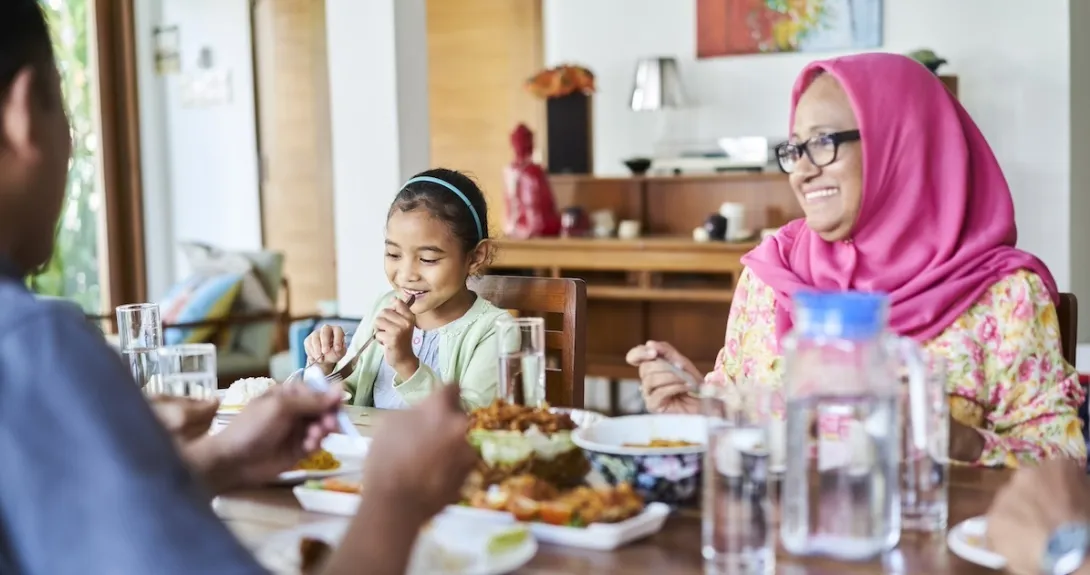Family sitting at a table eating dinner