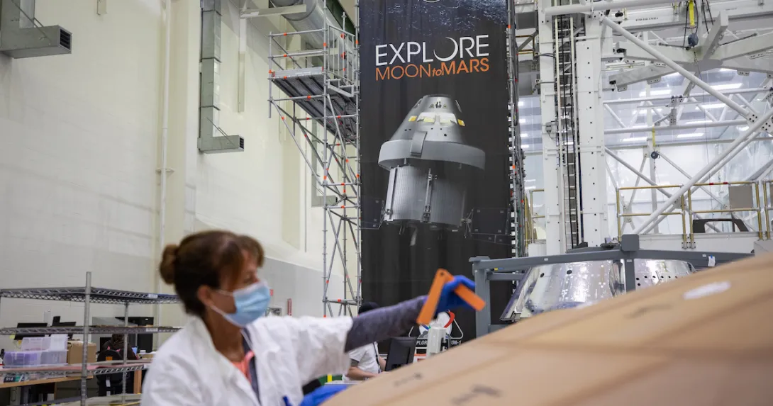 Darlene Beville with ASRC Federal inspects AVCOAT block bonding on the Artemis II heat shield on July 2, 2020.