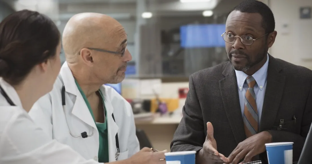 Clinicians in discussion with administrator