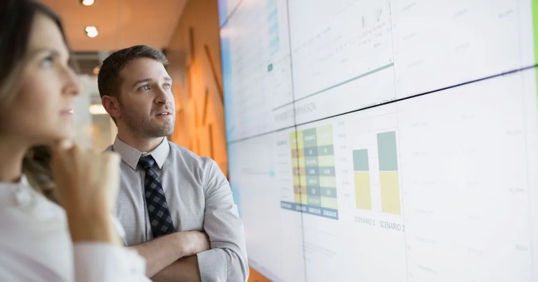 Businesspeople look at financial charts