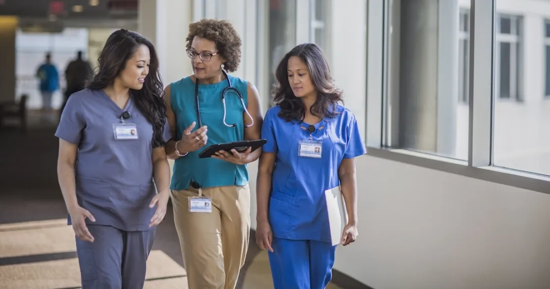 A doctor and nurses walking together in a hospital.