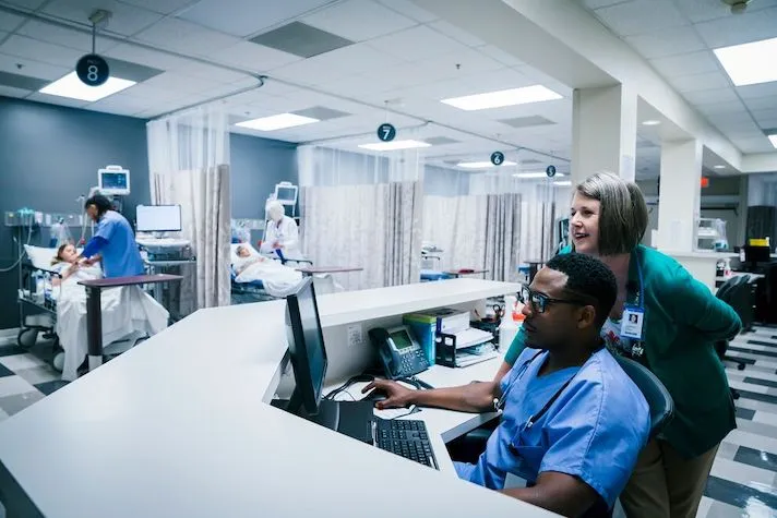 Medical professionals using computer in hospital