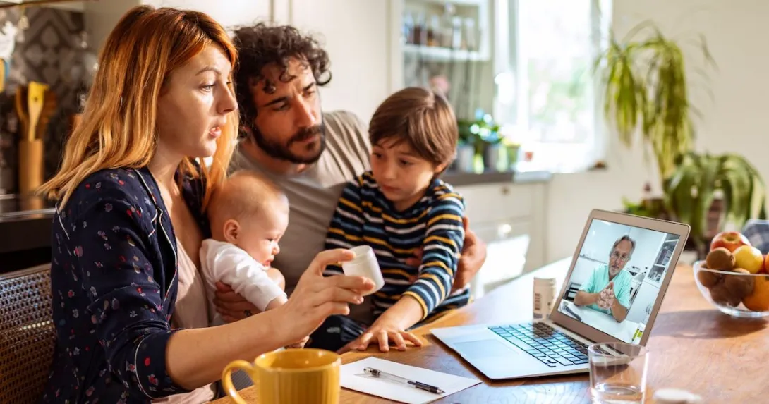 A family talking to a doctor on a laptop