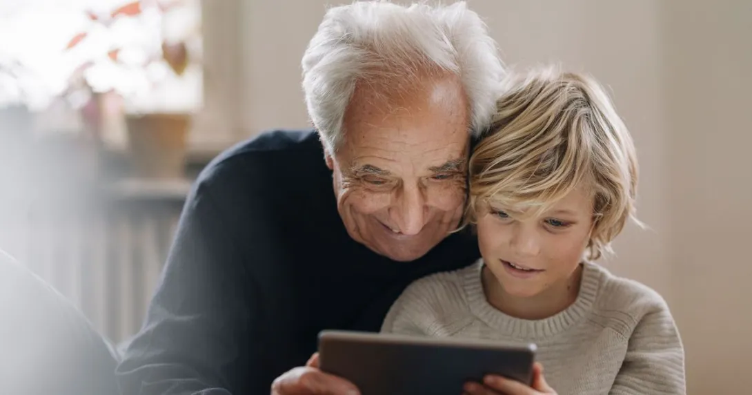 An adult and a child using a tablet together