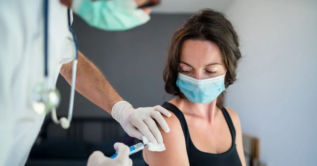 A woman receiving a vaccine.
