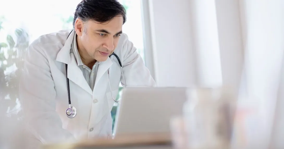 Healthcare provider looking at a computer