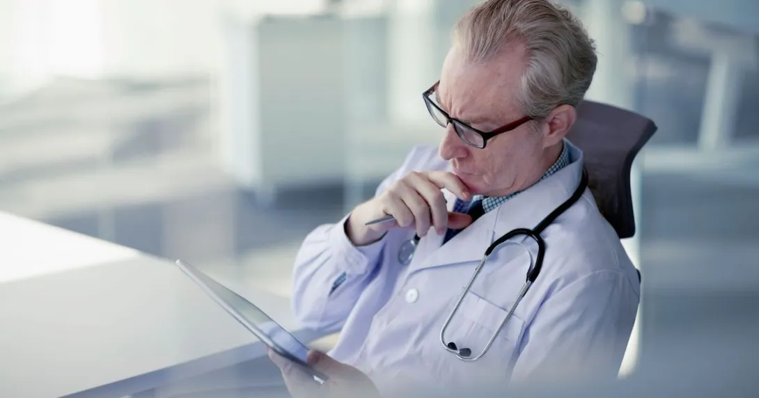Healthcare provider looking at a tablet