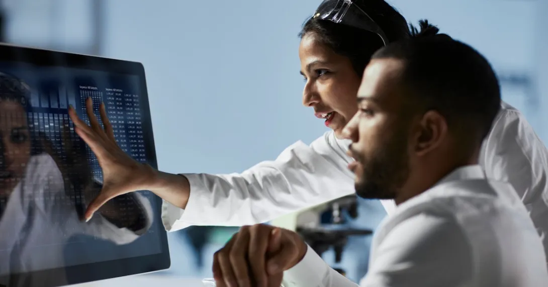 Two healthcare providers looking at a computer screen