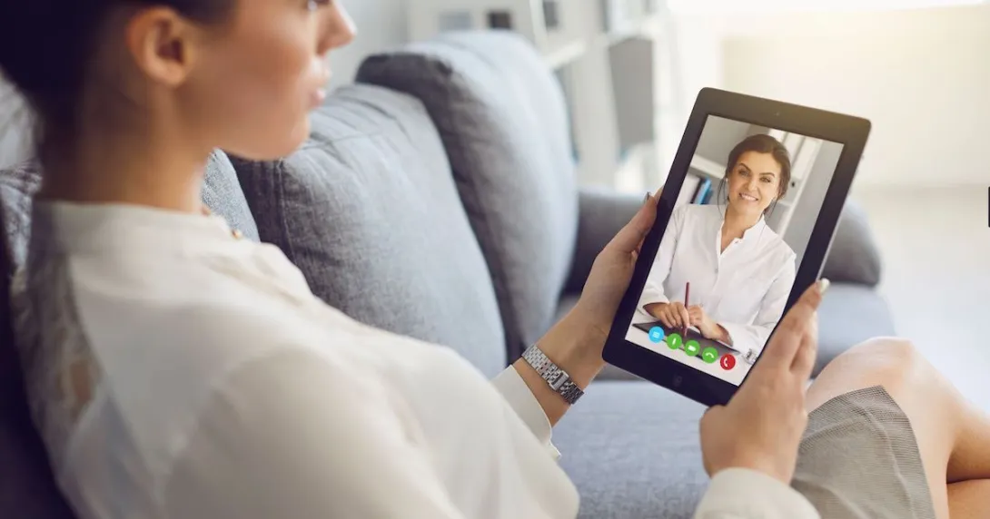 Person speaking to a healthcare provider via a tablet