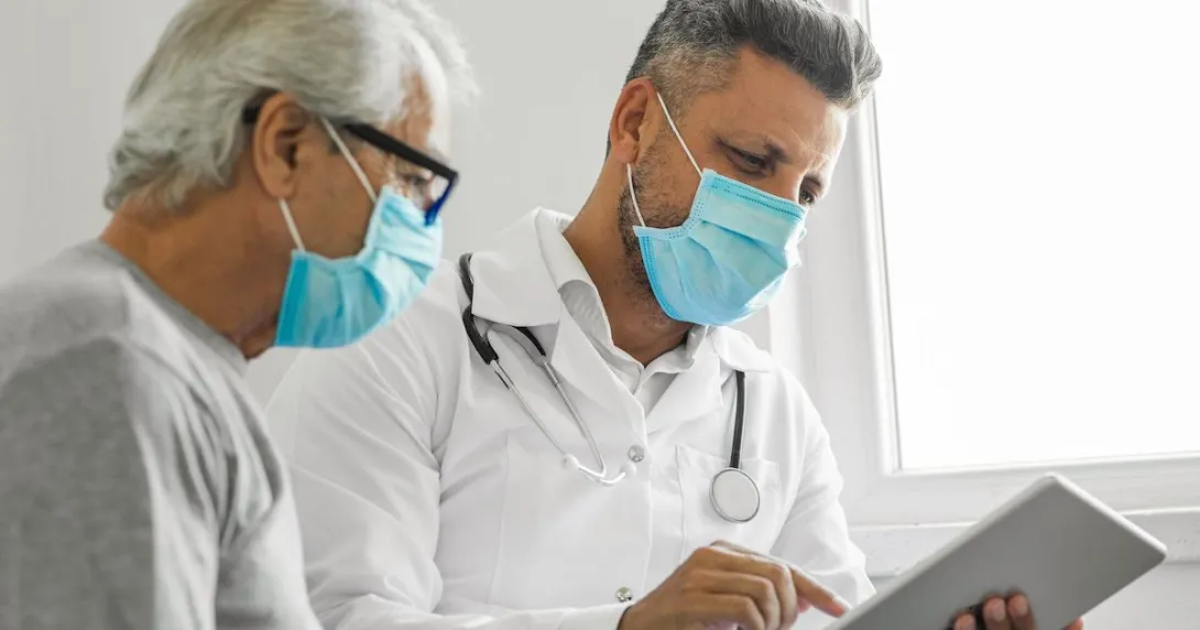 Healthcare provider and patient looking at a tablet