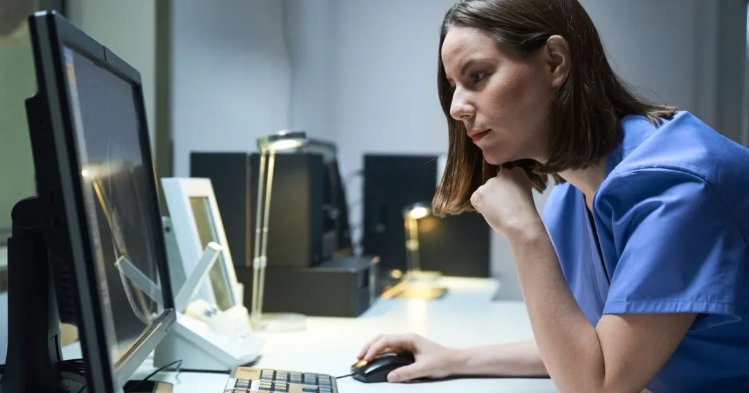 A medical professional using a desktop computer